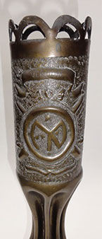 Shell with a crown of arches, banner VERDUN, number 104, Division insignia, crossed cannons