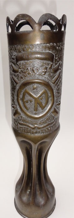 Shell with a crown of arches, banner VERDUN, number 104, Division insignia, crossed cannons