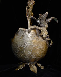 Metal basket&nbsp; with pedestal of leaves, bird. Oudside shell&nbsp; with gold and silver tones&nbsp; of circles&nbsp; and flower paterns.