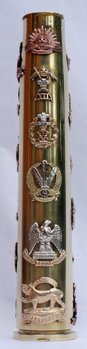 Shell Bofors dated 1944&nbsp; with 19 British cap Badges soldered