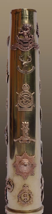 Shell with three sets of six British army cap badges soldered on a 40mm Bofors dated 1944