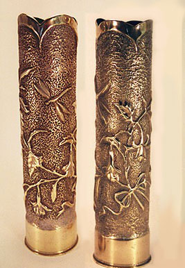 Pair of shells with bellflowers and dragonflies embossed, twigs tied by ribbon, top scalloped.