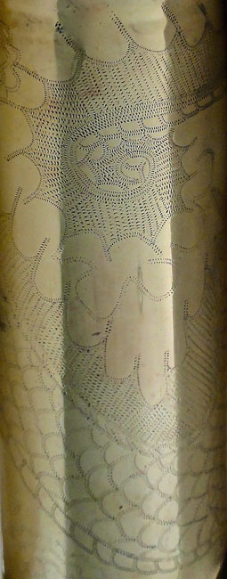 Shell engraved with dragon. Scaly and spiky tails ends up as a spiral . Zig-Zag work done probably post WWI.