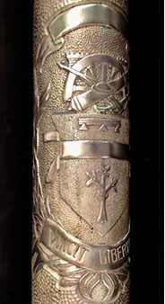 Upper band, below:&nbsp; a group of Engineers castle, half-finished spoked wheel, cannon, cavalry saber, rifle, doughboy helmet,&nbsp; then an escutcheon.