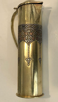 Pitcher with lid and handle. Decorative upper band of vine and grapes inlaid in silver and copper. Bezalel oval stamp at bottom.