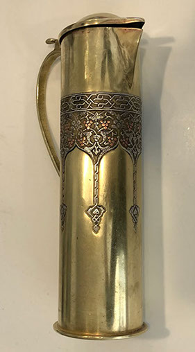 Pitcher with lid and handle. Decorative upper band of vine and grapes inlaid in silver and copper. Bezalel oval stamp at bottom.