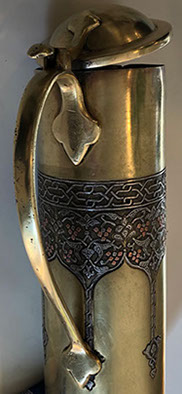 Shell with lid and handle. Upper decorative band inlaid in silver for the vines and copper for the grapes. Bezalel oval stamp at bottom.