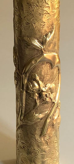 Shell embossed with a good luck horseshoe and roses on a background of Old Man's beard flowers. 