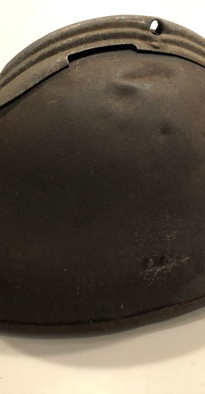 Adrian helmet with a bullet hole.