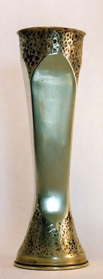 Shell flattened to a square section polised&nbsp; to achieve a contrast with base and decorated with dot punches