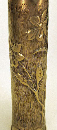 Shell with roses, prickly stems, leaves on a background with vertical indentations