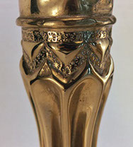 Shells fluted . Detail of spoked wheel punch pattern on a zig-zag band, an upper band, and triangles.