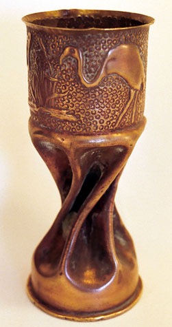 Shell with two flamingos next to a bush of reeds. Body fluted and twisted.