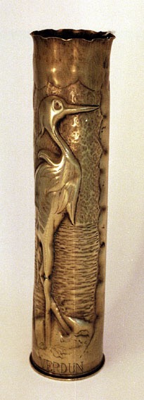 Shell with a heron in a marshland near a rippled lake.