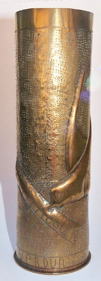 Shell with swallow bringing banner engraved MONTFAUCON. Verdun engraved on lower band