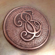 Jewel box in shape of a book. Lid with central medallion in copper&nbsp; with initials E and B